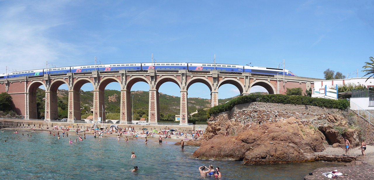 Trem passa por cima de ponte dos arcos em praia de Côte D' Azur, no sul da França