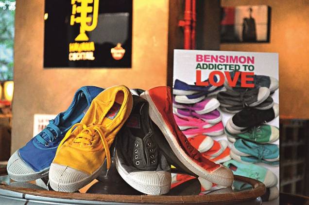 Em contrapartida, toda essa globalização não comprometeu o charme das boutiques. Lojas de redes como American Apparel, Agnès B., Sandro e Loft by Design chegaram com tudo, mas, nas lojinhas cheias de cores da Quai de Valmy, quem manda são os descolados. A fachada vermelha pertence à livraria Artazart, cheia de livros de arte e penduricalhos de design que valem o garimpo. Grudada nela fica a <a href="https://www.bensimon.com/fr/" rel="Bensimon," target="_blank">Bensimon,</a> marca dos famosos tênis Conga, febre nos anos 70 e 80 no Brasil e usados aos montes pelos parisienses. A loja, que era para ser temporária, já está estabelecida no endereço há quase três anos e continua renovando seu estoque de sapatos coloridos e estampados e roupas a cada estação. Mais adiante fica o trio de lojas <a href="https://www.antoineetlili.com/" rel="Antoine et Lili." target="_blank">Antoine et Lili.</a> Com cores diferentes, cada fachada corresponde a um tema: roupas de adulto (verde), roupas infantis (rosa) e objetos de decoração (amarela). A marca tem filiais em outros endereços de Paris, mas nenhuma é páreo em charme. Perto dali fica a Rue de Marseille, repleta de pequenas boutiques déstockage: peças de grife com desconto. Très bobô! Em contrapartida, toda essa globalização não comprometeu o charme das boutiques. Lojas de redes como American Apparel, Agnès B., Sandro e Loft by Design chegaram com tudo, mas, nas lojinhas cheias de cores da Quai de Valmy, quem manda são os descolados. A fachada vermelha pertence à livraria Artazart, cheia de livros de arte e penduricalhos de design que valem o garimpo. Grudada nela fica a <a href="https://www.bensimon.com/fr/" rel="Bensimon," target="_blank">Bensimon,</a> marca dos famosos tênis Conga, febre nos anos 70 e 80 no Brasil e usados aos montes pelos parisienses. A loja, que era para ser temporária, já está estabelecida no endereço há quase três anos e continua renovando seu estoque de sapatos coloridos e estampados e roupas a cada estação. Mais adiante fica o trio de lojas <a href="https://www.antoineetlili.com/" rel="Antoine et Lili." target="_blank">Antoine et Lili.</a> Com cores diferentes, cada fachada corresponde a um tema: roupas de adulto (verde), roupas infantis (rosa) e objetos de decoração (amarela). A marca tem filiais em outros endereços de Paris, mas nenhuma é páreo em charme. Perto dali fica a Rue de Marseille, repleta de pequenas boutiques déstockage: peças de grife com desconto. Très bobô!