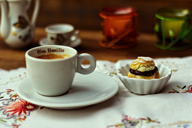 <strong>Bisa Basilio Café</strong>: 1 espresso acompanhado de 1 profiterólis recheado com ganache de chocolate e raspas de laranja, coberto com lascas de amêndoas (R$ 9,90) ou 1 espresso + 1 porção de mini pão de queijo (R$ 10,50)