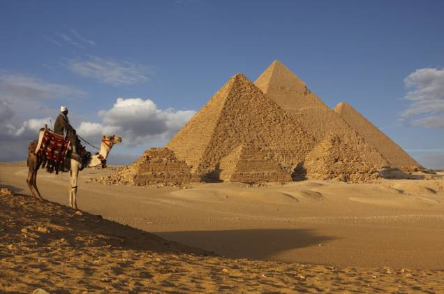 Beduíno e dromedário no platô de Gizé. Aos visitante, atenção, as pirâmides estão coladas aos subúrbios da cidade do Cairo