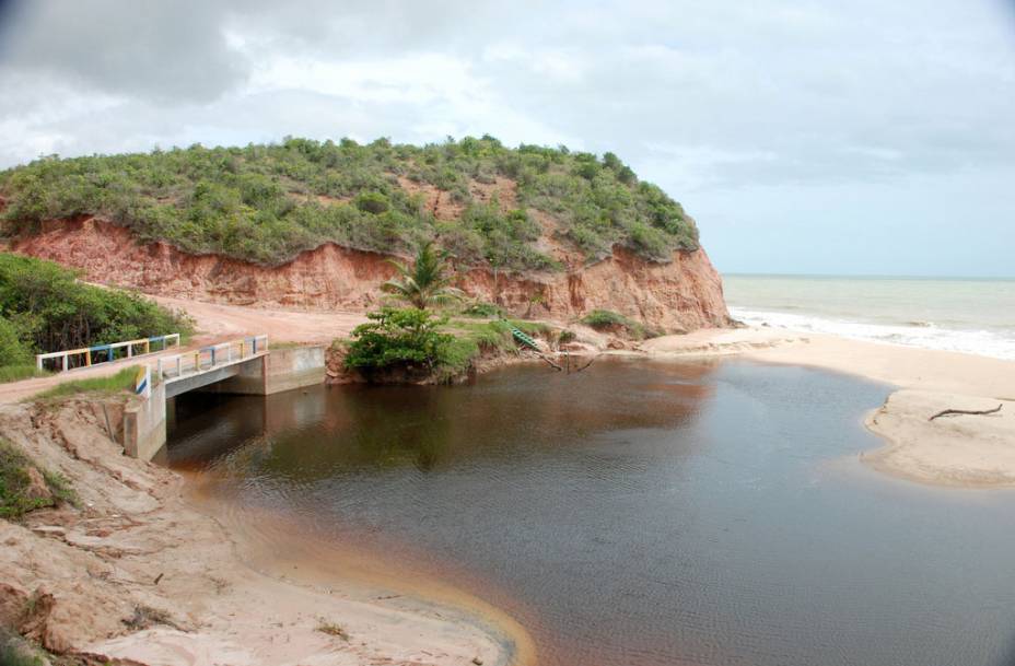 O mar da Praia de Japara Mirim é calmo e raso, e há grandes falésias na orla