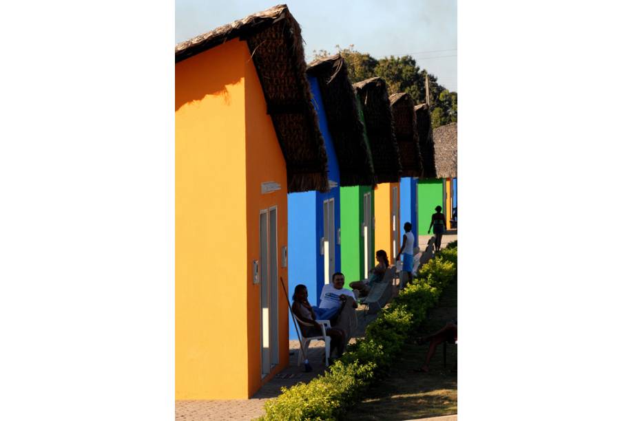 Moradores diante do casario colorido típico da cidade de São Pedro do Piauí (PI)