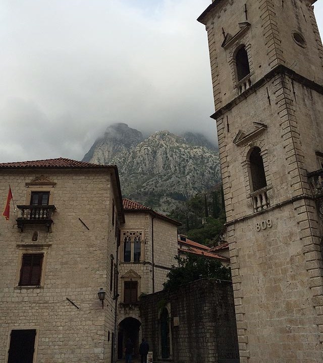 Torre da catedral e a montanha mergulhada nas nuvens